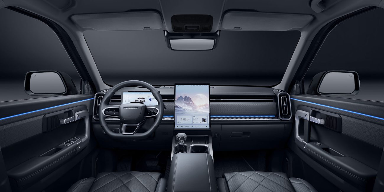 Jaecoo J7 SUV interior with large vertical touchscreen, digital dashboard, and blue ambient lighting.